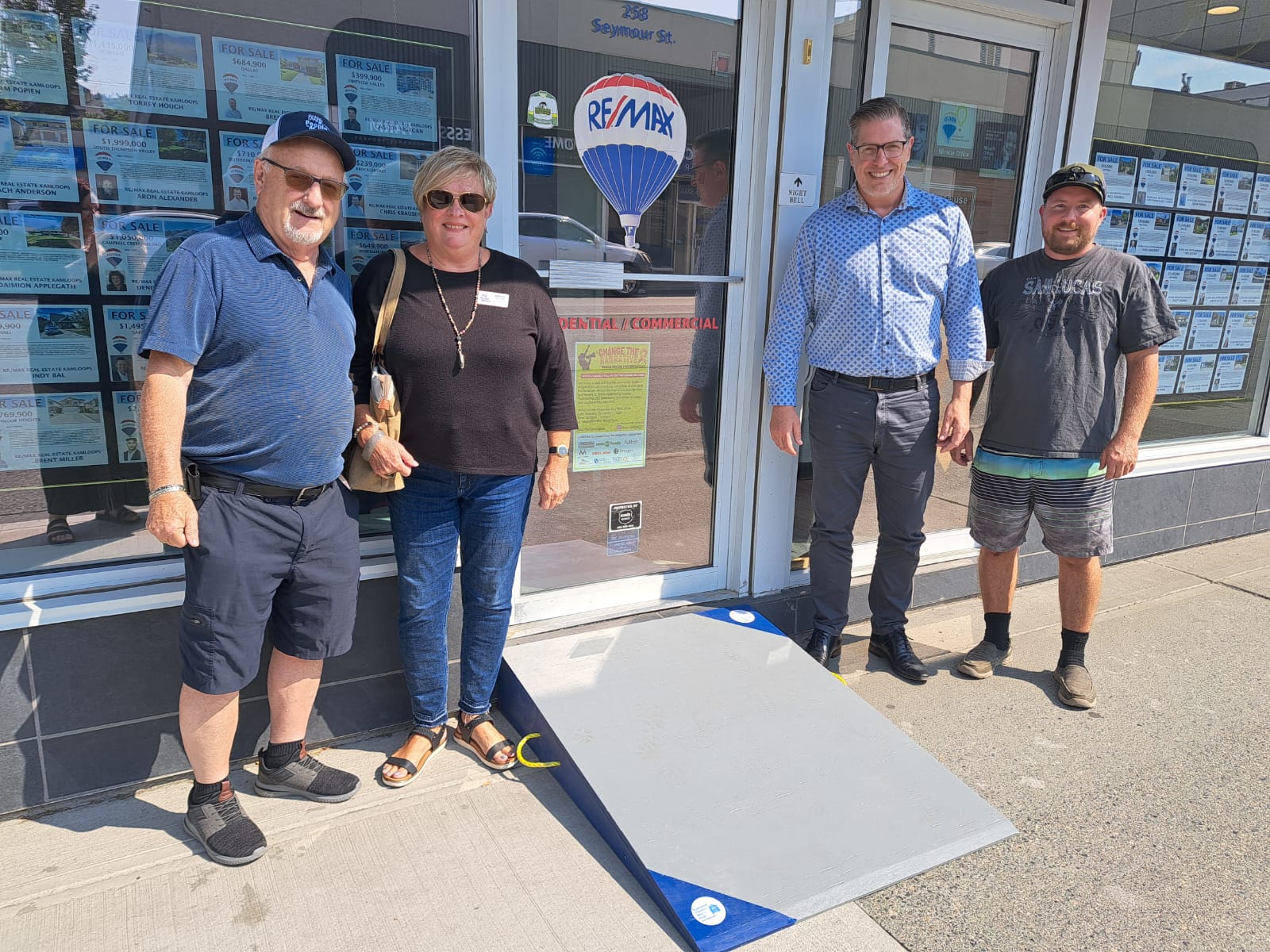 Downtown Remax office accepts delivery of an accessibility ramp